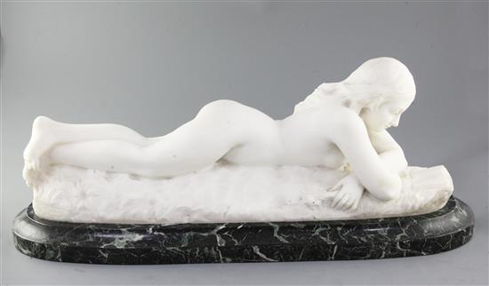 Charles R. Faggioni (19th/20th century). A white marble carving of a nude woman reclining reading a book, width 27in.